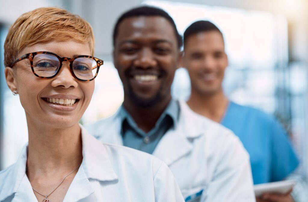 Black woman, portrait and doctors smile for teamwork, healthcare leadership and hospital management
