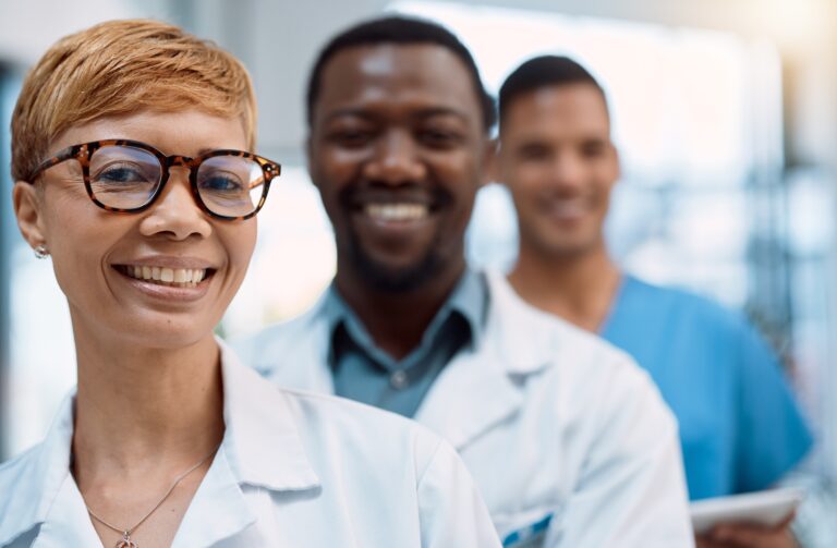 Black woman, portrait and doctors smile for teamwork, healthcare leadership and hospital management